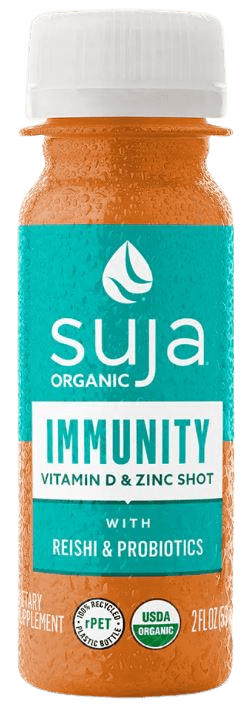 Suja Immunity Vitamin D and Zinc Shot bottle surrounded by fresh fruits and vegetables, symbolizing the natural ingredients and immune-boosting benefits of the product